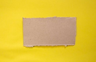 Torn paper piece isolated on yellow background