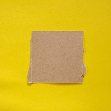 Torn paper piece isolated on yellow background