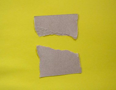 Set of torn paper pieces isolated on yellow background