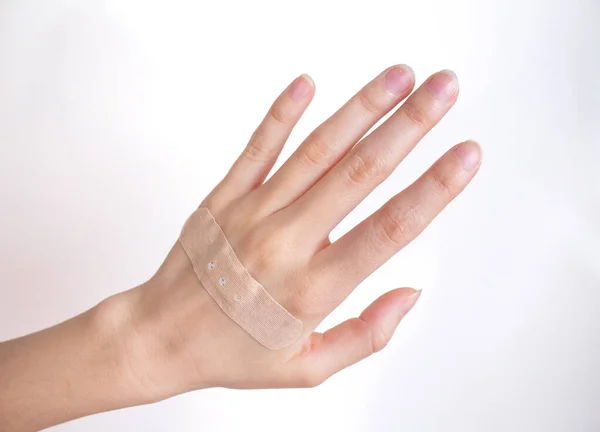 Adhesive bandage on female hand