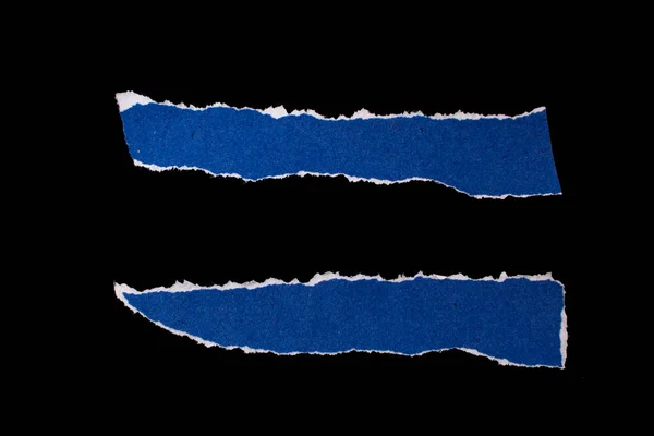 Blue torn paper pieces isolated on black background