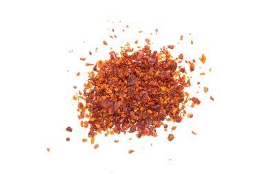 Chilli pepper flakes isolated on a white background. Top view, flat lay.