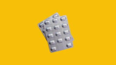 Pack of pills rotating on yellow background. Medicine animation.