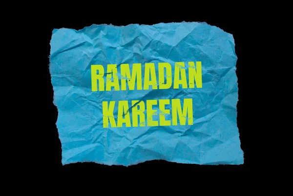 Ramadan Kareem word written on paper. Ramadan celebration background.