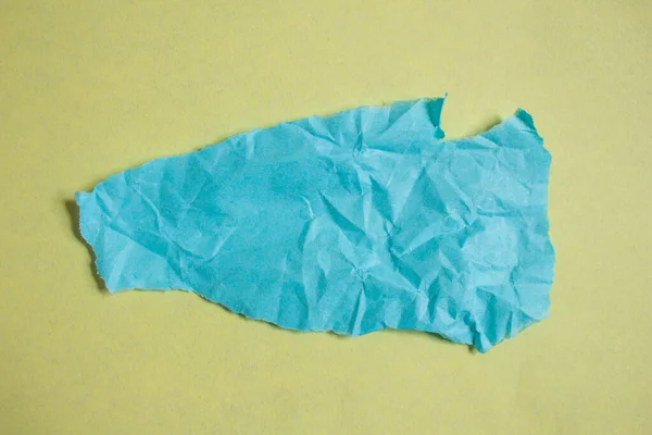 Creased Blue Paper Piece Yellow Background Crumpled Torn Paper Edge — Stock Photo, Image