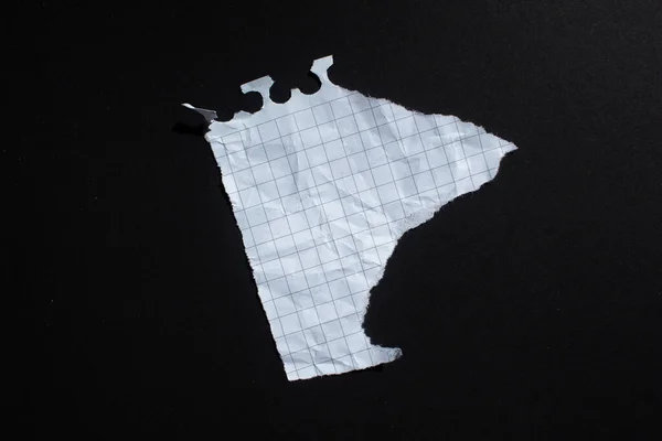 stock image Ripped white graph paper on black background. Torn paper background with copy space.