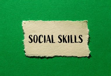 Social skills words written on ripped paper piece with green background. Conceptual social skills symbol. Copy space. clipart