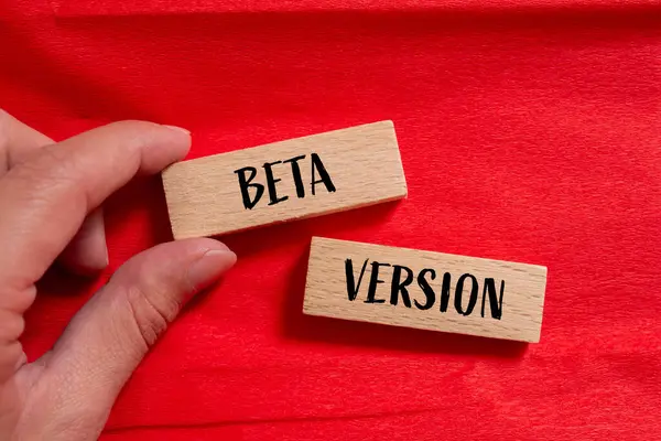 Stock image Beta version words written on wooden blocks with red background. Conceptual beta version symbol. Copy space.