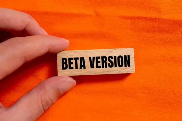 stock image Beta version words written on wooden block with orange background. Conceptual beta version symbol. Copy space.