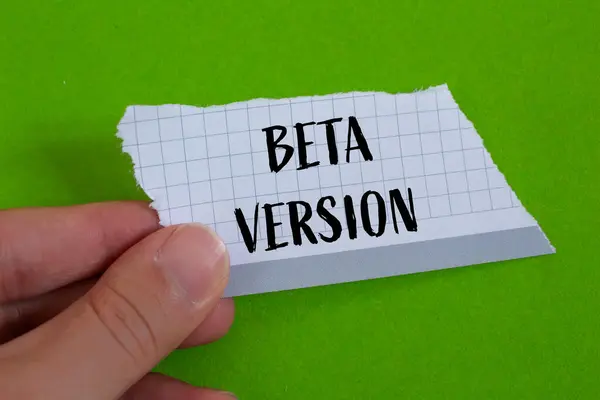 stock image Beta version words written on ripped paper with green background. Conceptual beta version symbol. Copy space.