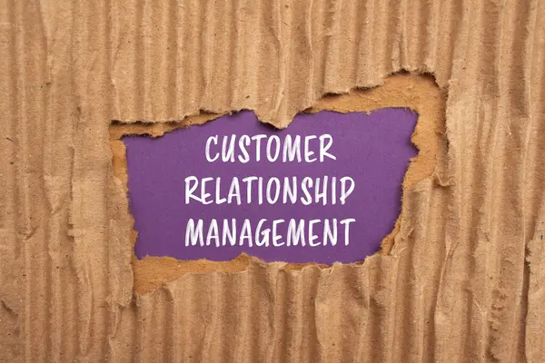 Customer Relationship Management Woorden Geschreven Gescheurd Karton Papier Met Paarse Stockfoto