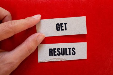 Get results message written on paper pieces with red background. Conceptual get results symbol. Copy space. clipart