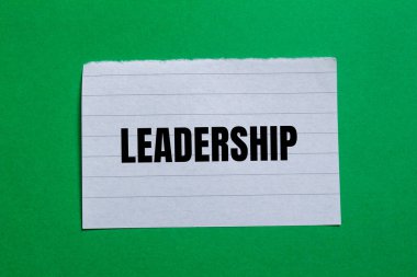 Liderlik mesajı yeşil arka planlı yırtık kağıt parçasına yazılmış. Kavramsal liderlik sembolü. Boşluğu kopyala.