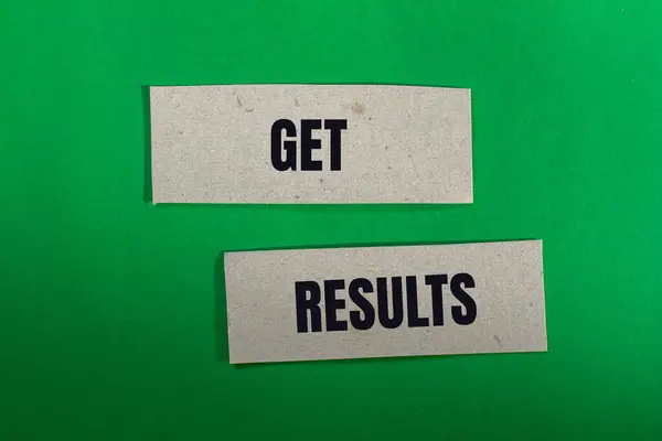 stock image Get results message written on paper pieces with green background. Conceptual get results symbol. Copy space.