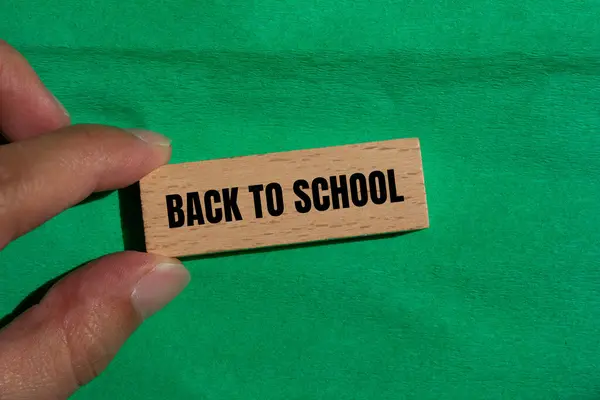 stock image Back to school message written on wooden block with green background. Conceptual back to school symbol. Copy space.