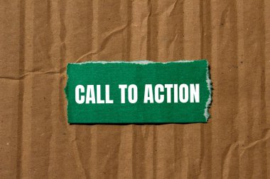 Call to action message written on ripped torn green paper piece with cardboard background. Conceptual call to action CTA symbol. Copy space. clipart