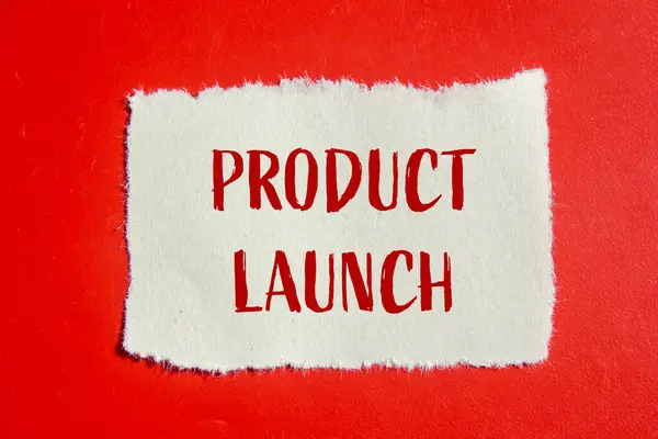 stock image Product launch message written on ripped torn paper piece with red background. Conceptual product launch symbol. Copy space.