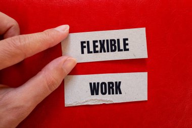 Flexible work message written on paper pieces with red background. Conceptual flexible work symbol. Copy space. clipart