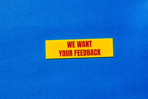 stock image We want your feedback message written on yellow sticker with blue background. Conceptual we want your feedback symbol. Copy space.