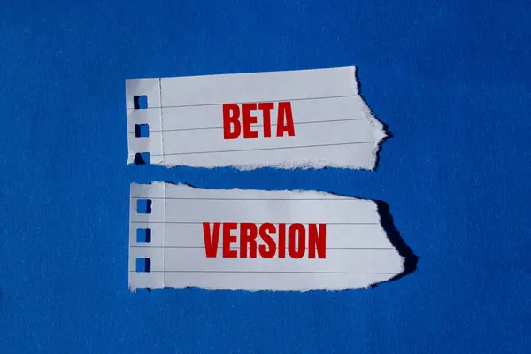 stock image Beta version message written on ripped torn paper pieces with blue background. Conceptual beta version symbol. Copy space.