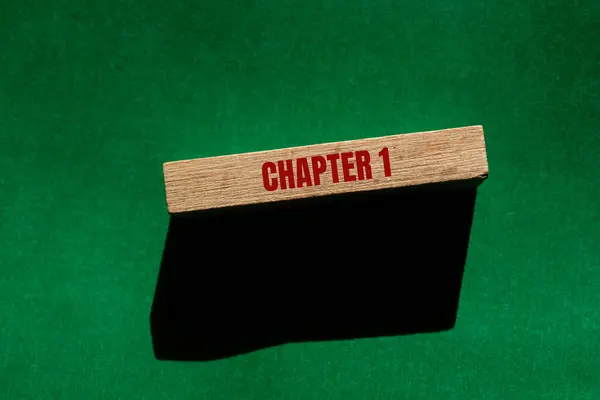 stock image Chapter 1 message written on wooden block with green background. Conceptual chapter 1 symbol. Copy space.