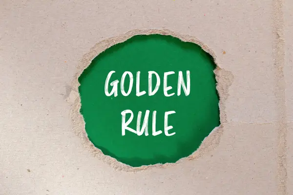 stock image Golden rule message written on ripped torn paper with green background. Conceptual golden rule symbol. Copy space.