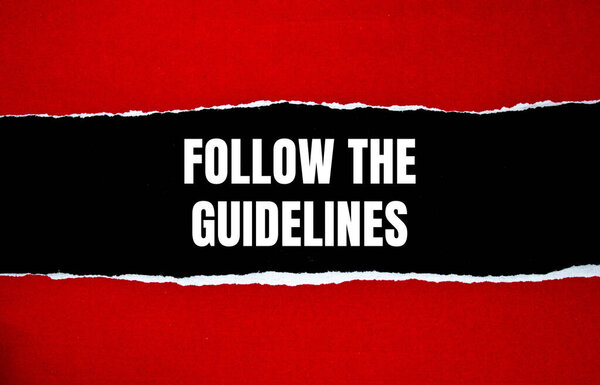 Follow the guidelines message written on ripped torn red paper with black background. Conceptual follow the guidelines symbol. Copy space.