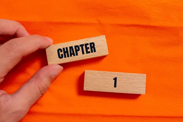 stock image Chapter 1 message written on wooden blocks with orange background. Conceptual chapter 1 symbol. Copy space.