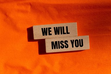 Tahta bloklara, turuncu arka planda yazılmış mesajınızı özleyeceğiz. Kavramsal olarak senin sembolünü özleyeceğiz. Boşluğu kopyala.