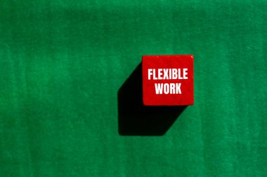 Flexible work message written on red wooden cube with green background. Conceptual flexible work symbol. Copy space. clipart