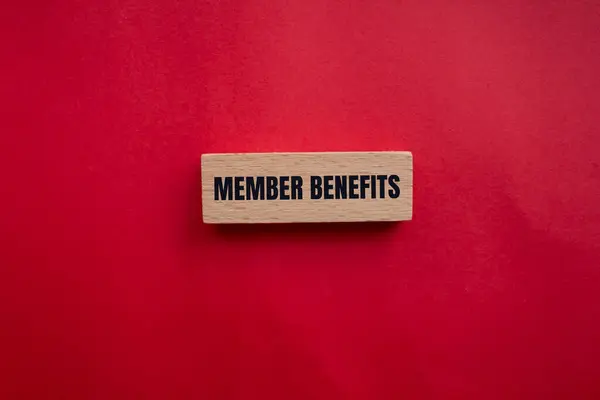 stock image Member benefits message written on wooden block with redbackground. Conceptual member benefits symbol. Copy space.