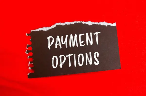 stock image Payment options message written on ripped torn black paper piece with red background. Conceptual payment options symbol. Copy space.