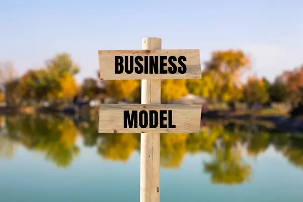 stock image Business model message written on wooden sign with blurry nature background. Conceptual business model symbol. Copy space.