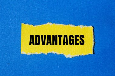 Advantages message written on ripped yellow torn paper piece with blue background. Conceptual advantages symbol. Copy space. clipart