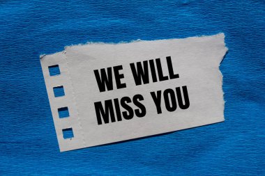 We will miss you message written on ripped torn paper piece with blue background. Conceptual we will miss you symbol. Copy space. clipart