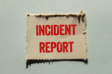 Gri arkaplandaki yırtık kağıt parçasına olay raporu mesajı yazılmış. Kavramsal olay raporu sembolü. Boşluğu kopyala.