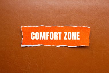 Kahverengi arkaplanlı turuncu yırtık kağıt parçasına yazılmış rahat bölge mesajı. Kavramsal konfor bölgesi sembolü. Boşluğu kopyala.