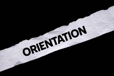 Siyah arka planda yırtık beyaz kağıda oryantasyon mesajı yazılmış. Kavramsal yönelim sembolü. Boşluğu kopyala.