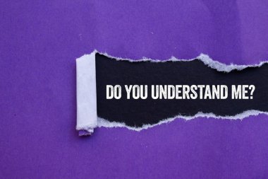 Do you understand me message written on ripped torn purple paper on black background. Conceptual do you understand me symbol. Copy space. clipart