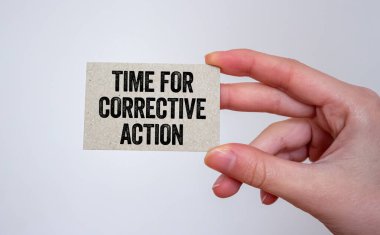 Elindeki karta yazılan düzeltici eylem mesajı zamanı. Düzeltici eylem sembolü için kavramsal zaman. Boşluğu kopyala.