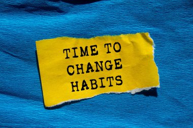 Mavi arka plandaki yırtık sarı kağıda yazılan alışkanlık mesajını değiştirme zamanı. Alışkanlık sembolünü değiştirmek için kavramsal zaman. Boşluğu kopyala.