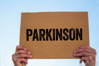 Karton levhaya Parkinson mesajı yazılmış. Kavramsal Parkinson sembolü. Boşluğu kopyala.