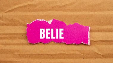 Believe message written on ripped torn paper background. Conceptual Believe symbol.