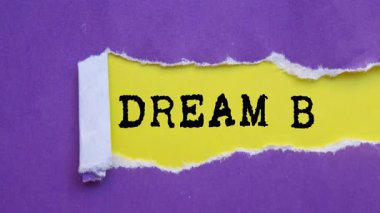 Dream Big message written on ripped torn paper background. Conceptual Dream Big symbol.