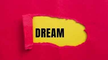Dream Big message written on ripped torn paper background. Conceptual Dream Big symbol.