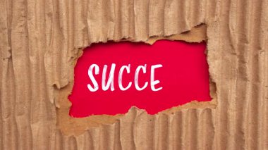 Success message written on ripped torn paper background. Conceptual Success symbol.