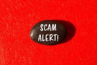 Scam alert message written on stone background. Conceptual Scam alert symbol. Copy space.