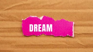 Dream Big message written on ripped torn paper background. Conceptual Dream Big symbol.