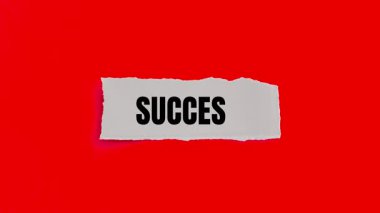 Success message written on ripped torn paper background. Conceptual Success symbol.