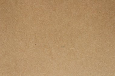 Brown kraft paper texture background. Natural recycled cardboard surface with subtle fiber details, perfect for packaging, eco-friendly design projects and craft applications.